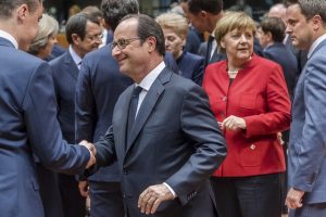 French President Francois Hollande, center, greets Estonian Prime Minister Taavi Roivas, left, as German Chancellor Angela Merkel, 2nd right, talks with Luxembourg's Prime Minister Xavier Bettel during an EU summit in Brussels on Thursday, Oct. 20, 2016. British Prime Minister Theresa May is set to hold her first talks with EU leaders and will tell them that the U.K.'s decision to leave the bloc is irreversible. (AP Photo/Geert Vanden Wijngaert)
