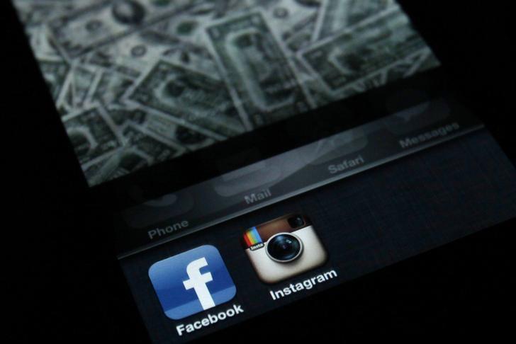 A photo illustration shows the applications Facebook and Instagram on the screen of an iPhone in Zagreb April 9, 2012.  REUTERS/Antonio Bronic/Files